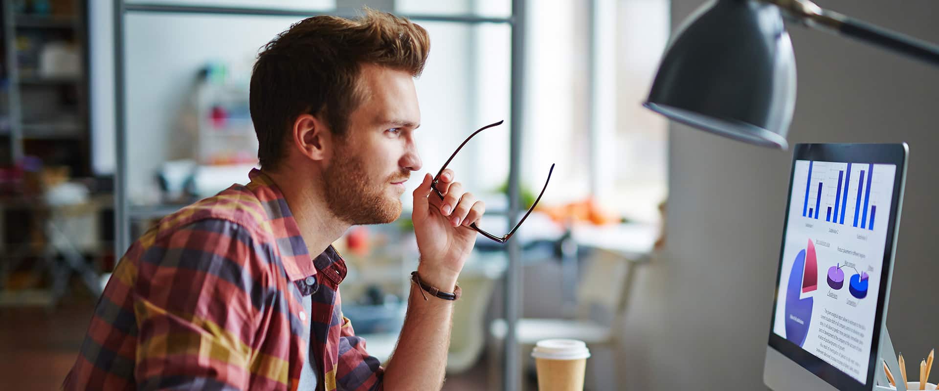 Man as a designer sitting at his table and working on computer